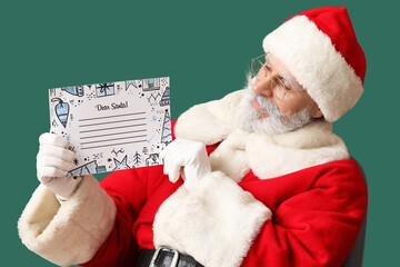 Santa Claus with blank letter on color background