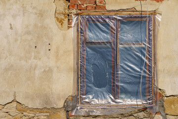 The window of an old emergency dwelling. Poverty and misery