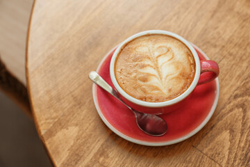 Cup of delicious coffee on table in cafe