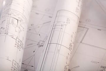 Rolled Blueprints Construction Plans on the desk