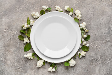 Composition with table setting and snowberries on grey background