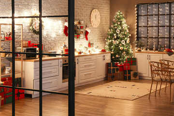 Interior of kitchen with beautiful Christmas tree, gift boxes, decor and modern furniture