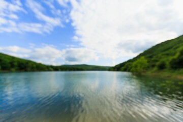 Blue water in a forest lake with pine trees