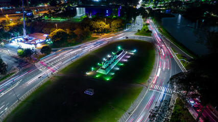 Fototapeta na wymiar Monumento As Bandeiras in Ibirapuera Park in São Paulo, SP, Brazil. Night aerial view. Hyperlapse. Selective focus