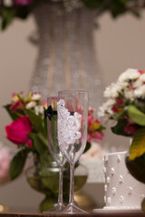 Bride and groom cup with flowers in background wedding day