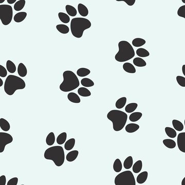 black footprints of a cat on a white background. seamless abstraction of animal footprints for clothing or print