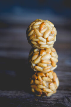 Stack of traditional Catalonian panellets with pine nuts on a table