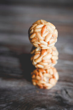 Stack of traditional Catalonian panellets with pine nuts on a table