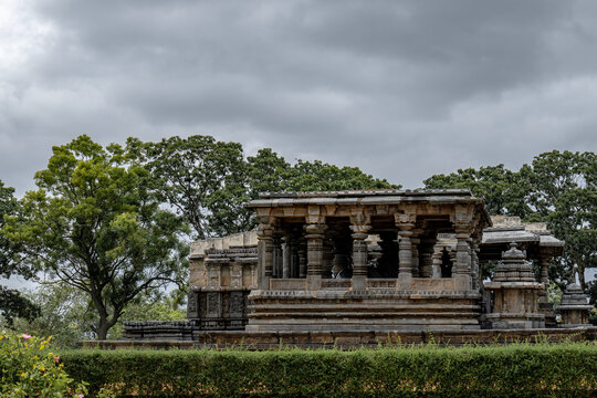 Ancient Halebidu temple (Hoysaleswara temple) against a cloudy sky in Karnataka, India