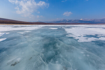 Beautiful ice of a frozen lake. Overall plan. Sikhote-Alin Biosphere Reserve in the Primorsky Territory.