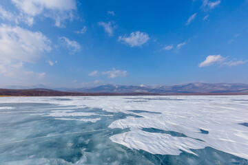 Fototapeta na wymiar Beautiful ice of a frozen lake. Overall plan. Sikhote-Alin Biosphere Reserve in the Primorsky Territory.