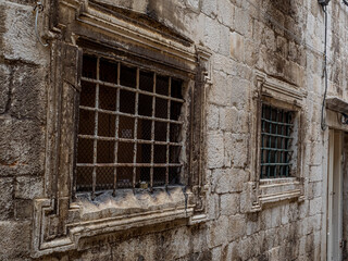 Ironclad window covering set into fortified stone wall around Dubrovnik, Croatia.
