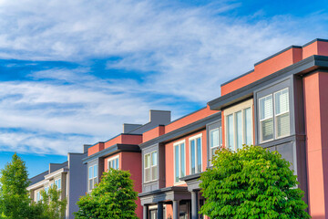 Townhouses building with coral and dark gray siding at Daybreak, Utah