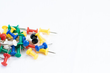 Colored push pins in different colors with white background.