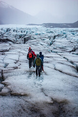 A Group of Hikers Uses Picks and Steel Spikes to Hike in the Rain on the Sv&iacute;nafellsj&ouml;kull Glacier in Skaftafell National Park, Iceland