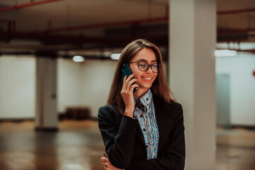 An attractive business woman in glasses using a smartphone. Selective Focus. Business Portrait