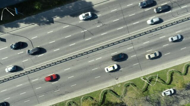 Slow turning shot above of road with moving cars.