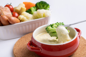チーズホンデュとカラフルな蒸し野菜　
パーティー料理が並ぶ白いテーブル