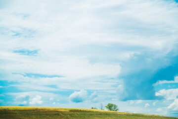 Fototapeta premium Beautiful hilly landscape in the foreground with blue sky