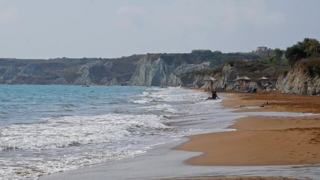 Rugged Cliffs And Brown Fine Sand At The Remote Beach Of Megas Lakkos In Greece. wide shot