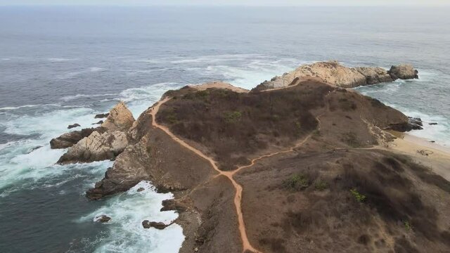 Pull front above  Punta Cometa, with view of cliffs, in Oaxaca, Mexico