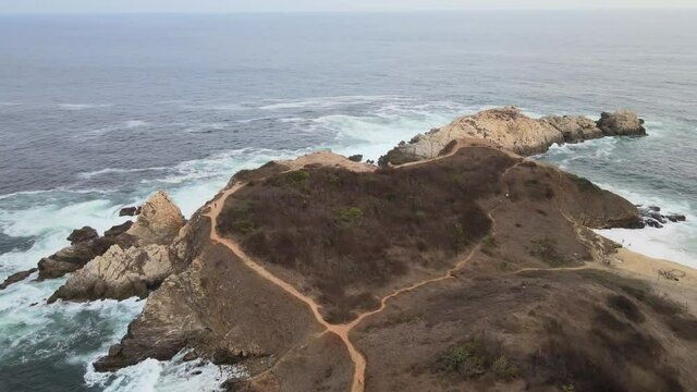 Pull back above  Punta Cometa, with view of cliffs, in Oaxaca, Mexico