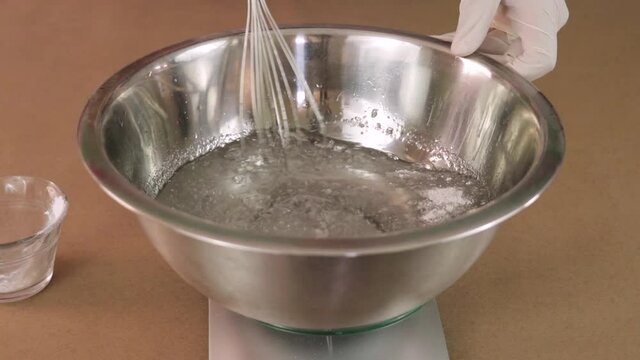 Mixing chemical ingredients in a bowl. Experiments.
