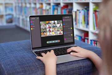 Caucasian girl using laptop for video call, with smiling diverse elementary school pupils on screen