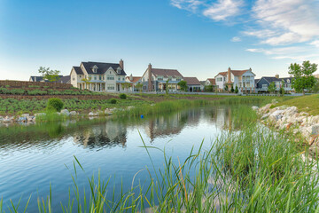Fototapeta na wymiar Oquirrh Lake with a reflection of the residential houses at Daybreak, Utah