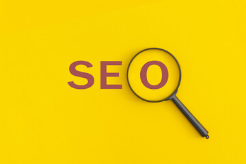 The word seo on yellow background.  Top view. Flat lay.