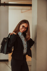 A business woman in a suit with a briefcase in her hand goes to work. Selective focus. Business concept