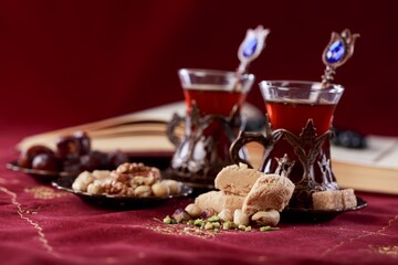 Traditional sweet food with tea and nuts Ramadan food