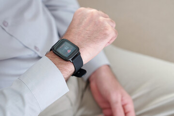 Man suffering from tachycardia checking heartbeat with help of application on smartphone