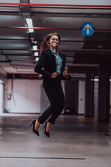 Obraz premium A successful business woman celebrates her job by jumping into the air. Selective focus