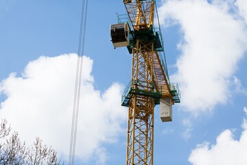 Construction site, workers and cranes.