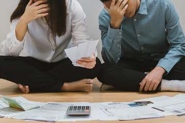 Stressed owe asian young couple love family  sitting confused calculate expense from invoice or bill, have no money to pay. Mortgage, loan causing debt, bankruptcy. Debt problem, Financial People.