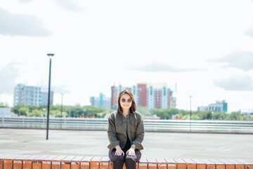 Young Beautiful Asian Woman Wearing Jacket And Black Jeans Posing Outdoors