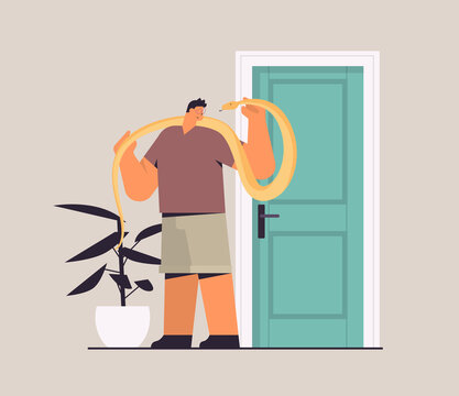 man holding yellow python snake guy having dangerous reptile pet horizontal full length