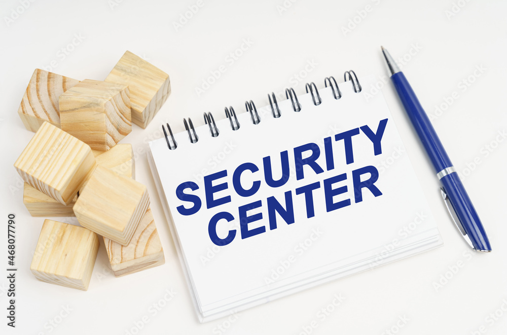 Poster on the table are cubes, a pen and a notebook with the inscription - security center