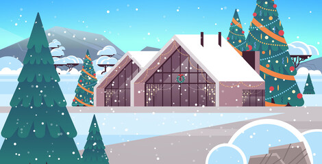 snow covered decorated house in winter season home building with decorations for new year and christmas celebration