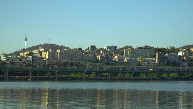 Namsan Tower or N Seoul Tower over blue sky from the riverfront of Hangang river, South Korea in Autumn