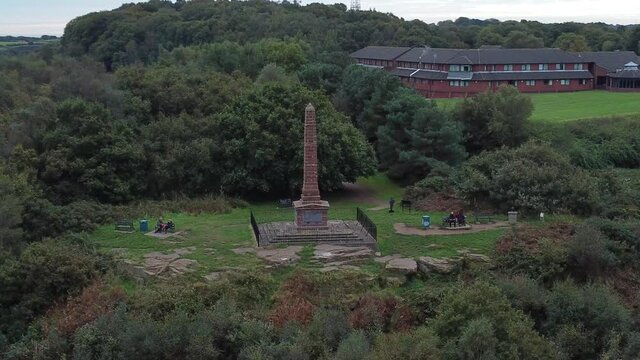 Aerial view sandstone obelisk war memorial Frodsham hill overlooking Cheshire Liverpool skyline
