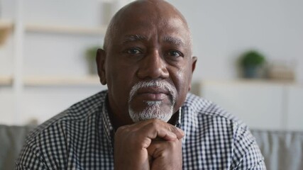 Aging and retirement. Close up portrait of peaceful senior bearded african american man looking at camera at home - Powered by Adobe