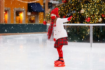 Kids ice skating in winter. Ice skates for child.