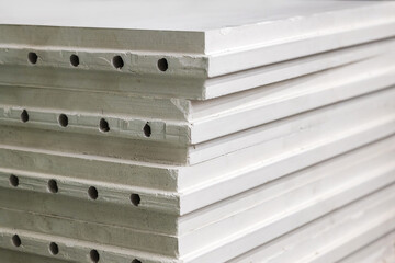 The gypsum plate is hollow hollow and moisture-resistant. Construction industry. Focusing with a small depth of field.