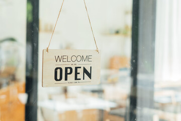 Wooden sign board hanging on door of cafe