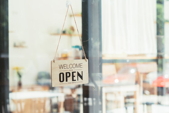 Wooden sign board hanging on door of cafe