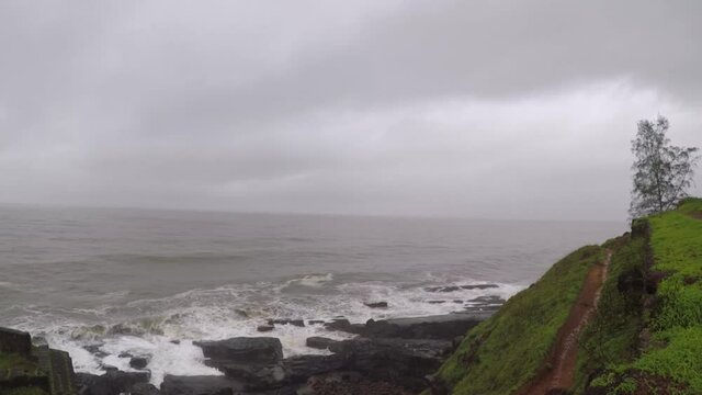 Devil's eye goa in monsoon. It is also known as devil's finger near Sinquerim Fort to Lower Aguada. Water waves crash into rocks and Sea foam creating amazing shapes and patterns