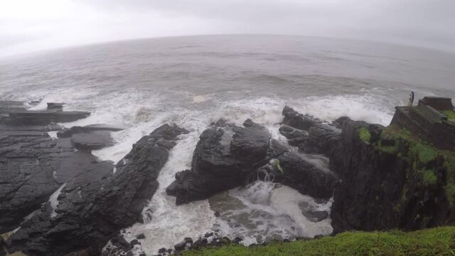 Devil's eye goa in monsoon. It is also known as devil's finger near Sinquerim Fort to Lower Aguada. Water waves crash into rocks and Sea foam creating amazing shapes and patterns