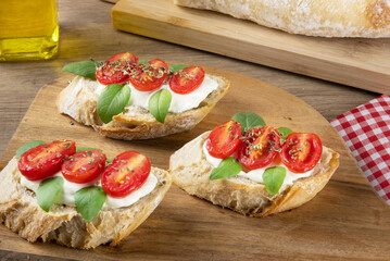 Delicious bruschetta with cream cheese, tomato and basil.